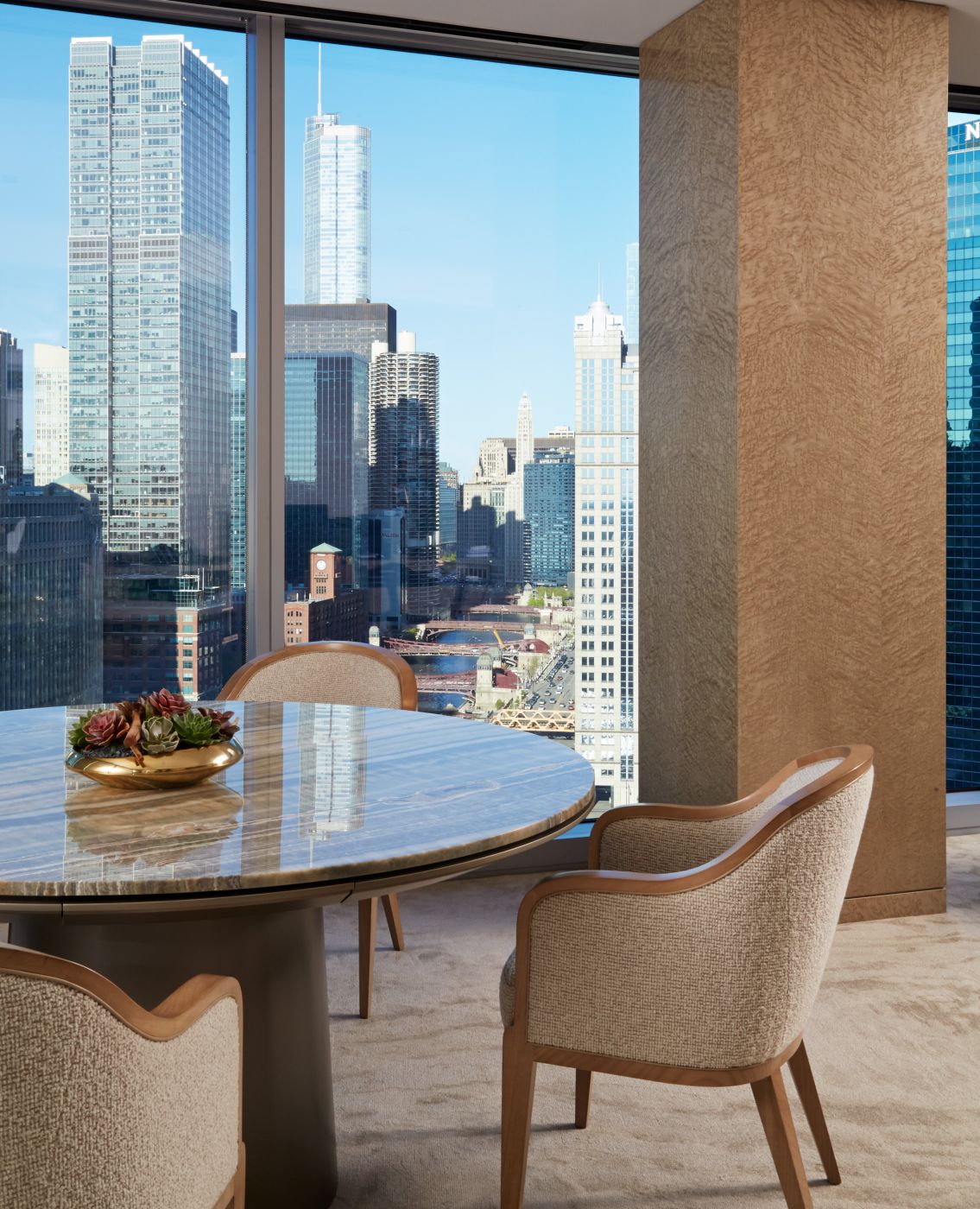 Stone surfaced MESA table with satin chrome trim.